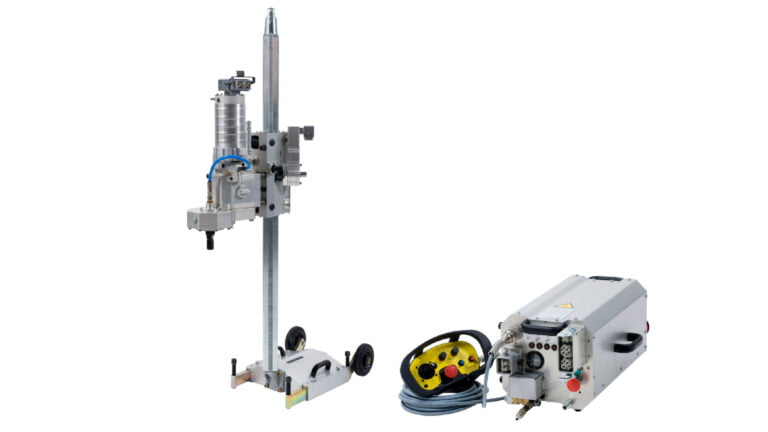 a core drill attached to a drill rig and a power pack.