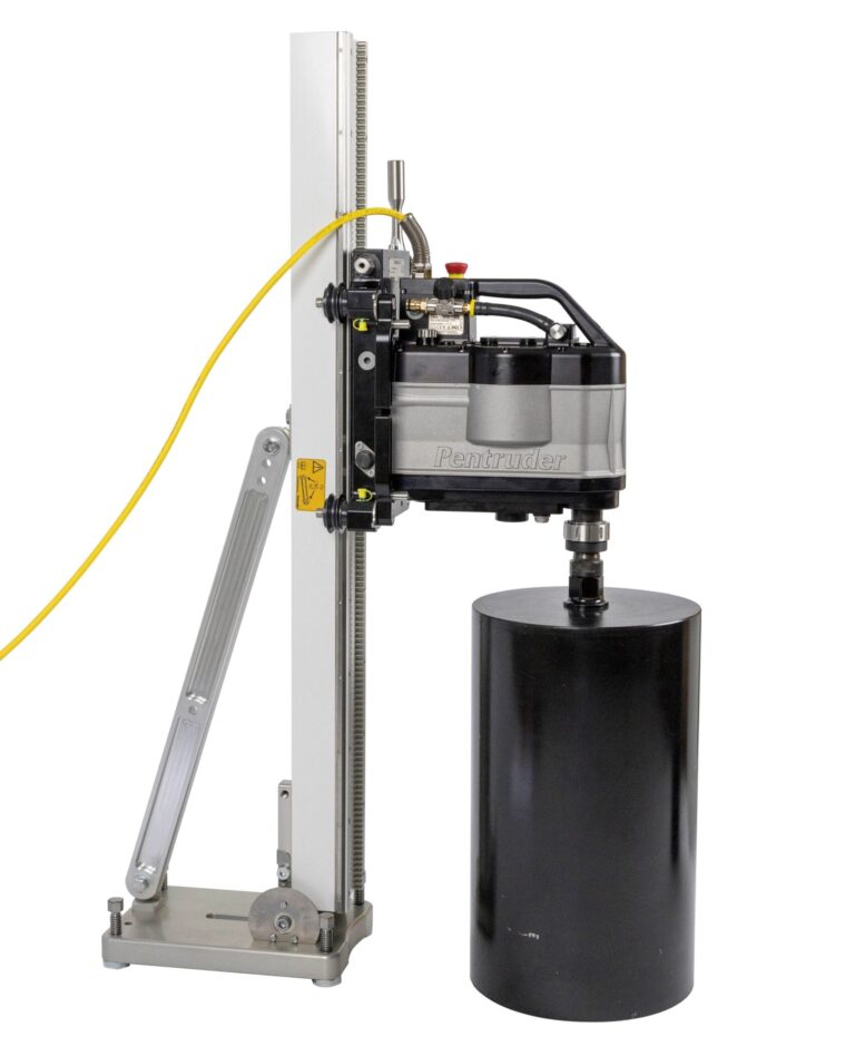the MDU3-60 is a black and silvery drill motor, here with a yellow cable and a black core bit on a drill rig